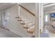 Traditional wood and white staircase with view into living area at 109 Carolina Blvd, Isle of Palms, SC 29451