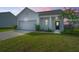 Charming home featuring a well-maintained lawn, attached garage, and cozy front porch at 109 Lyra Ln, Summerville, SC 29486