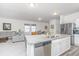 Open kitchen featuring a granite island, stainless steel appliances, and an adjacent living area at 109 Lyra Ln, Summerville, SC 29486
