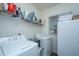 Functional laundry room with a washer, dryer, storage shelves, and natural light at 109 Lyra Ln, Summerville, SC 29486
