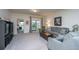 Inviting living room with carpet flooring, recessed lighting, and sliding door access to the backyard at 109 Lyra Ln, Summerville, SC 29486