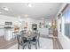 Open-concept living and dining area with stainless steel appliances and hardwood floors at 109 Lyra Ln, Summerville, SC 29486