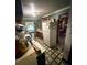 Narrow galley kitchen featuring neutral cabinets, appliances, and decorative elements at 1124 Davidson Ave, Charleston, SC 29407
