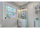 Charming bathroom featuring a glass enclosed shower, stained glass window and updated vanity at 1188 Camden St, North Charleston, SC 29405