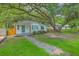 Charming front exterior of a cozy home surrounded by lush landscaping and a stone walkway at 1188 Camden St, North Charleston, SC 29405