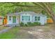 Charming single-story home featuring a green door, white brick, and mature trees in the front yard at 1188 Camden St, North Charleston, SC 29405