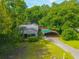 Charming home with covered parking surrounded by lush trees and green lawn at 145 Ravenell Dr, Saint Stephen, SC 29479