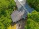 Aerial view of rooftop solar panels and surrounding lush tree canopy at 145 Ravenell Dr, Saint Stephen, SC 29479