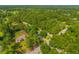 Aerial view of lush landscape featuring a charming home surrounded by mature trees at 145 Ravenell Dr, Saint Stephen, SC 29479