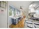 Functional kitchen with a gas range, blue-trimmed windows, and vinyl flooring at 145 Ravenell Dr, Saint Stephen, SC 29479