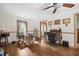 Bright living room with wood-look flooring, natural light, and vintage desk at 145 Ravenell Dr, Saint Stephen, SC 29479