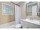 Functional bathroom with a bathtub, white vanity, and neutral-toned tile, offering a clean design at 1525 Westmoreland Ave, Charleston, SC 29412