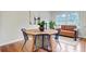 Inviting dining area with wood table, chairs, decorative plants, and view of the bright interior at 1525 Westmoreland Ave, Charleston, SC 29412