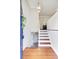 Bright foyer featuring hardwood floors, modern lighting, white walls, and a glimpse into the open kitchen at 1525 Westmoreland Ave, Charleston, SC 29412