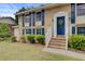 Inviting brick home featuring a striking blue door, white trim, brick steps and manicured shrubbery at 1525 Westmoreland Ave, Charleston, SC 29412