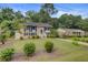 Well-maintained two-story home with a classic brick facade, manicured lawn, and mature trees at 1525 Westmoreland Ave, Charleston, SC 29412