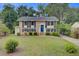 Charming two-story brick home with a lush lawn, blue shutters and door, and well-maintained landscaping at 1525 Westmoreland Ave, Charleston, SC 29412