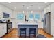Beautiful kitchen with white cabinets, an island with seating, and modern stainless steel appliances at 1525 Westmoreland Ave, Charleston, SC 29412