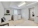 Bright laundry room with washer, dryer, storage, seating, and a window for natural light at 1525 Westmoreland Ave, Charleston, SC 29412