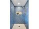 Close-up of the beautifully tiled walk-in shower with a rain shower head and built-in niche at 1525 Westmoreland Ave, Charleston, SC 29412