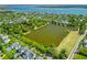 Aerial view capturing the community, highlighting Smythe Lake and lush trees in the landscape at 1530 Willtown St, Daniel Island, SC 29492