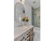 Bathroom featuring modern vanity with marble countertop, decorative flowers, and a shower with green subway tile at 1530 Willtown St, Daniel Island, SC 29492