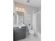 Well-lit bathroom featuring a modern vanity, toilet, and shower with white tile and a matching shower curtain at 1530 Willtown St, Daniel Island, SC 29492