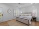 Bright bedroom with a light color scheme, wood floors, ceiling fan, and a comfortable bed with decorative pillows at 1530 Willtown St, Daniel Island, SC 29492