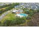 Aerial view of a community pool with clubhouse surrounded by lush landscaping and neighborhood homes at 1530 Willtown St, Daniel Island, SC 29492
