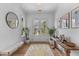Bright foyer with elegant decor, including a decorative rug, stylish bench and sun-filled front door at 1530 Willtown St, Daniel Island, SC 29492