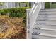 Close-up of the house number '1530' on a white staircase with lush greenery as a backdrop at 1530 Willtown St, Daniel Island, SC 29492