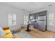 Open concept kitchen/living space featuring stainless steel appliances, and a cozy seating area with a small table at 1530 Willtown St, Daniel Island, SC 29492