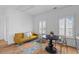 Bright living room featuring a comfortable seating area, wooden table, and natural light from shuttered windows at 1530 Willtown St, Daniel Island, SC 29492