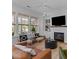 Bright living room with a fireplace, built-in shelves and large windows allowing for an abundance of natural light at 1530 Willtown St, Daniel Island, SC 29492