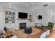 Cozy living room featuring a fireplace, built-in shelves, and comfortable seating arrangement at 1530 Willtown St, Daniel Island, SC 29492