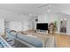 Large living room with vaulted ceilings, ceiling fans, a sectional sofa, and access to an ensuite bath at 1530 Willtown St, Daniel Island, SC 29492