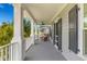 Relaxing covered porch features a comfortable wicker chair and decorative shutters for peaceful outdoor enjoyment at 1530 Willtown St, Daniel Island, SC 29492