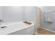 Clean and bright bathtub with tile flooring and a modern shower curtain at 1543 Bluewater Way, Charleston, SC 29414