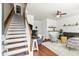 Bright entryway features hardwood floors, stairs with a carpet runner, and adjacent living space at 1543 Bluewater Way, Charleston, SC 29414