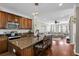 Open concept kitchen featuring wood cabinets, granite countertops, and hardwood floors at 1543 Bluewater Way, Charleston, SC 29414