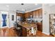 Spacious kitchen featuring wooden cabinetry, granite countertops, stainless appliances and hardwood floors at 1543 Bluewater Way, Charleston, SC 29414