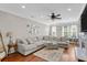 Bright living room features a large sectional sofa, recessed lighting, ceiling fan, and hardwood floors at 1543 Bluewater Way, Charleston, SC 29414