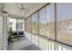Relaxing screened-in porch with brown sunshades, ceiling fan, and wood floors at 1543 Bluewater Way, Charleston, SC 29414