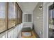 Inviting screened-in porch with porch swing and an outdoor carpet on the wooden floor at 1543 Bluewater Way, Charleston, SC 29414