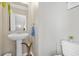 Powder room featuring pedestal sink, large mirror, and neutral paint at 1543 Bluewater Way, Charleston, SC 29414