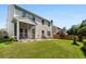 Well-maintained backyard featuring a screened porch, patio, and lush lawn ideal for outdoor enjoyment at 158 Balsam Cir, Summerville, SC 29485