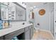 Stylish bathroom featuring a framed mirror, gray vanity, and neutral wall color at 158 Balsam Cir, Summerville, SC 29485