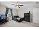 Bright bedroom with gray walls, carpet, ceiling fan, dark wood dresser, and a computer setup at 158 Balsam Cir, Summerville, SC 29485