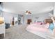 Large bedroom with carpet, ceiling fan, walk-in mirrored closet, and attached bath at 158 Balsam Cir, Summerville, SC 29485