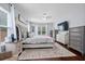 Large bedroom featuring a hardwood floor, bed, ceiling fan, dresser and an exterior window at 158 Balsam Cir, Summerville, SC 29485